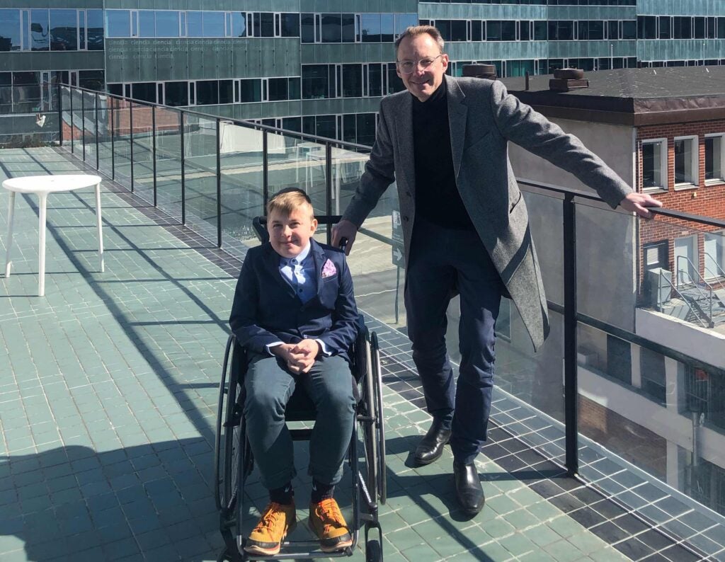 Sebastien poses for a photo with his son who has Duchenne muscular dystrophy.